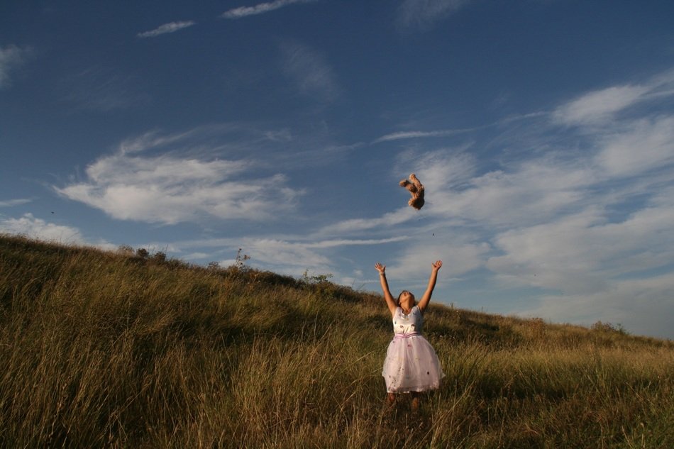 girl with teddy on the field