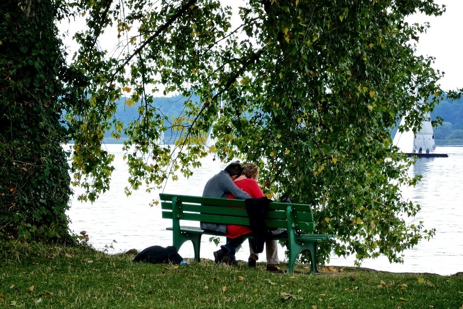 couple in love on benches by the river