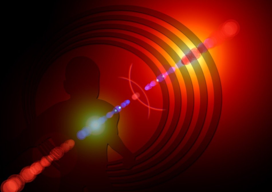 Silhouette of a man against a background of circles in the glare of light