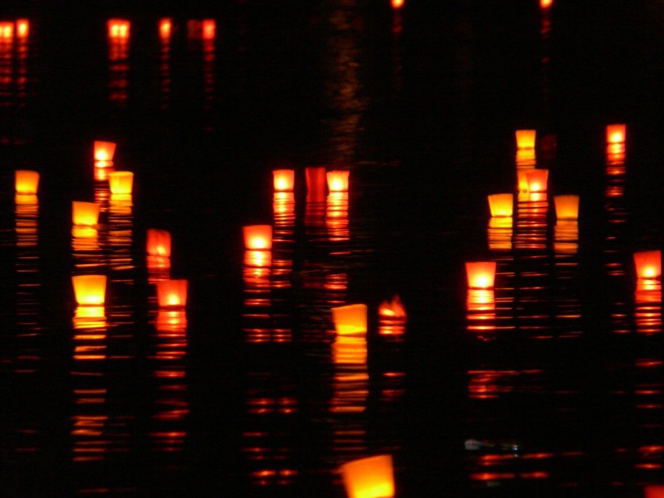 candles on the water at night