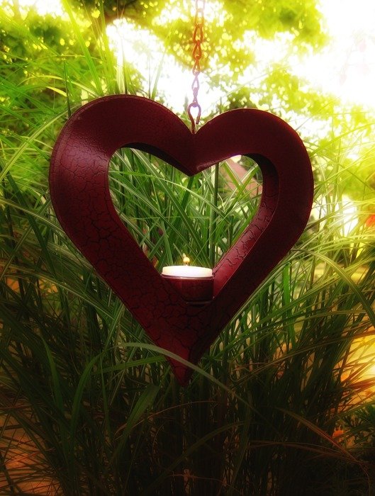 heart and candle in green rays