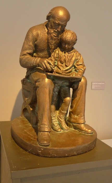 golden sculpture grandpa and grandson