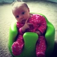Cute Baby Girl on green chair