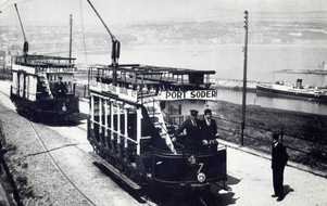 black and white photo of a retro tram