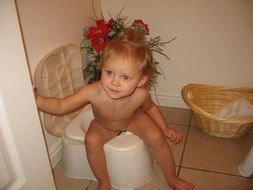 little girl sitting on a potty
