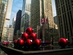 pyramid of red balls against the background of skyscrapers