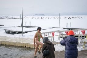 winter swimmer coming out of the cold water