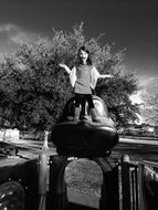 black white photo of a girl on the playground in the street