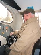 smiling senior man in locomotive cab