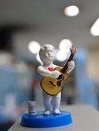 guitar boy figurine