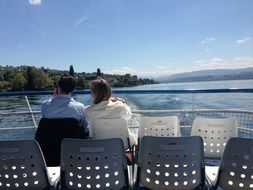 the couple rides the ship in a romantic setting