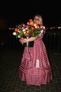 woman in a ball gown with flowers bouquet