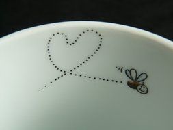 drawing on a plate of a fly and a heart trace