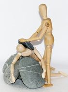 wooden figures of people near stones