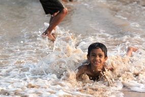 Happy boys are swimming in the water