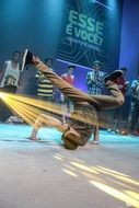 young man dancing brakedance on stage