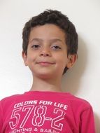 beautiful smiling boy in red and white t-shirt