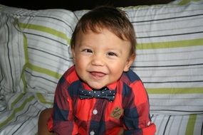 happy baby dressed in a shirt and tie