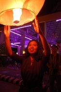 girl holding a paper lantern