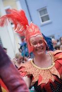 cheerful woman in red costume at the carnival