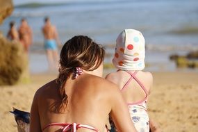 mother and small daughter on beach