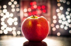 red apple surrounded by lights