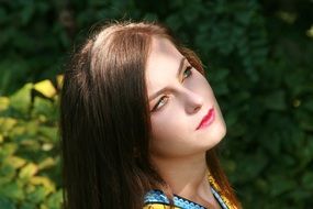 portrait of a girl on a background of vegetation