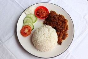 Ayam Penyet, indonesian dish with chicken, rice and vegetables