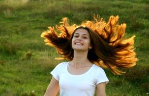 sun beams coming through the long hair of the girl