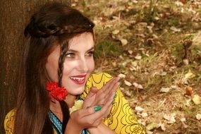 portrait of a seductive girl on a background of autumn leaves
