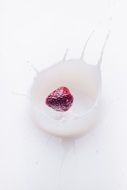strawberry dropping into milk