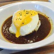 rice with cury paste and toped with eggs and cheese sause