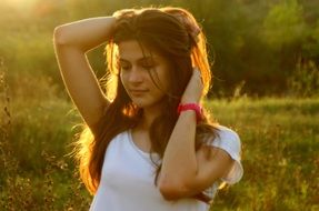 tender girl with long hair on a background of nature