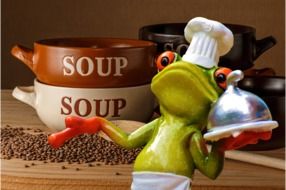 frog chef with a tray and big bowls of soup