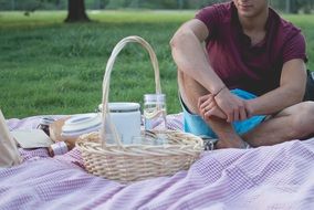 man is sitting in a park at picnic