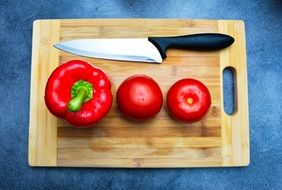 pepper and tomatoes on a cutting board