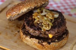 delicious greasy homemade burger with beef onions and cheese