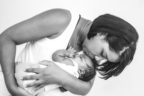 black and white foto of mother and her newborn baby