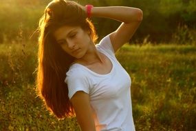girl with a thoughtful look on nature background