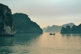 landscape of a boat surounded by mountains and nature