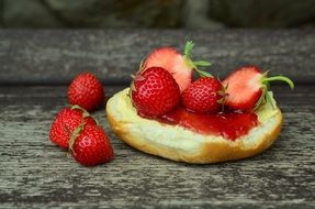fresh strawberry and jam on a cut bun