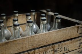 muddy corked glass bottles in wooden case