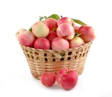 braided basket with pinky-red apples