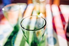 empty transparent glass on colourful bench