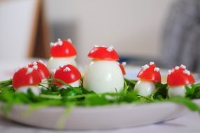 boiled eggs with tomato halves on top
