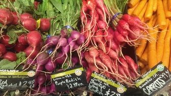 different types of radish and carrots at the market