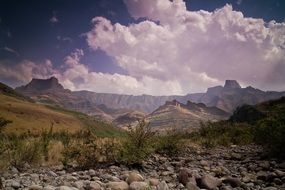 landscape of mountains with large puffy clouds