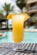 a glass of juice by the pool