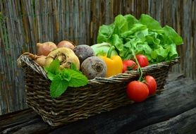 wooden basket with fresh juicy vegetables