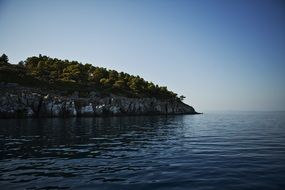 cliff among calm clear water